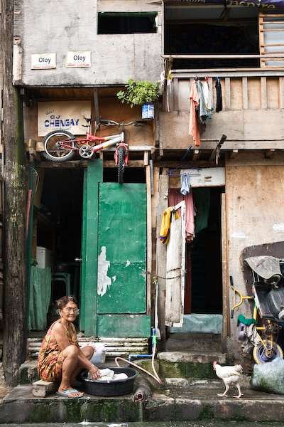 Woman wasihng clothes. Makati, Manila.